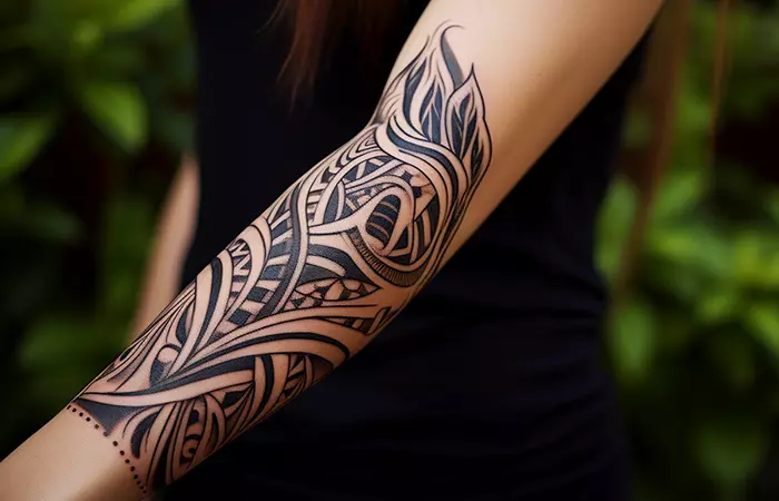 A woman with polynesian tribal tattoo on her arm