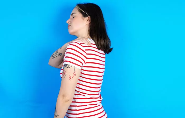 Woman with tattoos having body aches