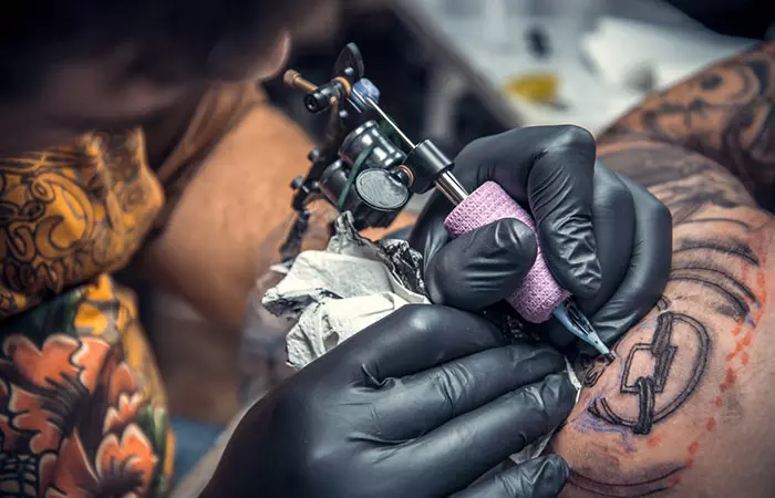 Tattoo artist drawing a tattoo