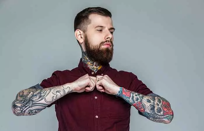 A man flaunts a type of neo-traditional tattoo on his forearms