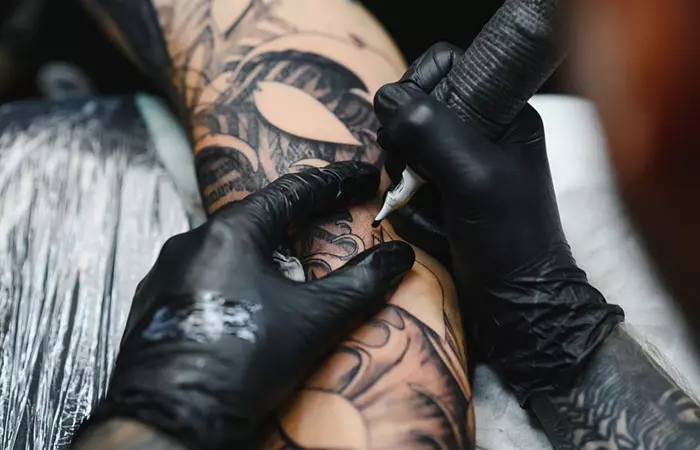 Man getting tattooed by professional tattooist