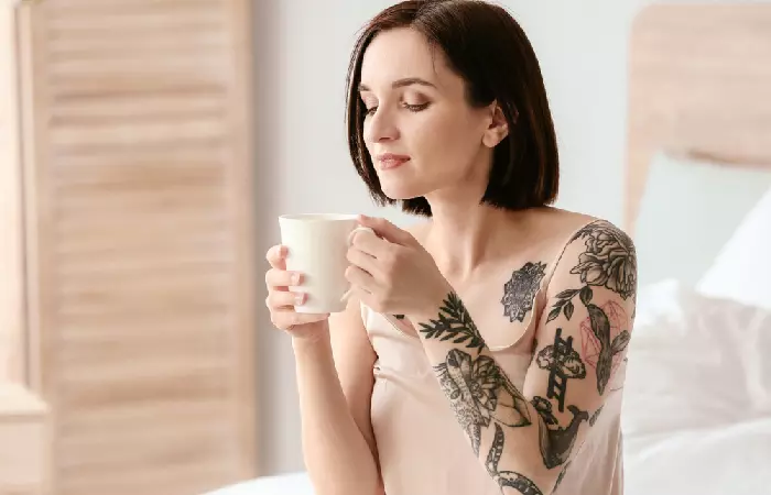 Woman drinking caffeine hours after getting a tattoo
