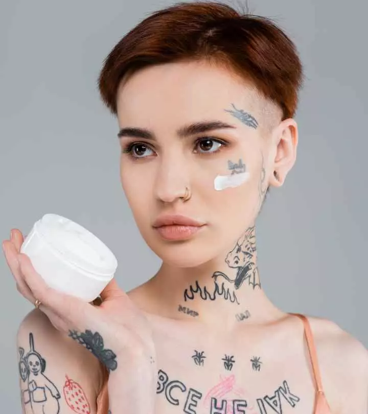 Woman using cocoa butter for tattoo