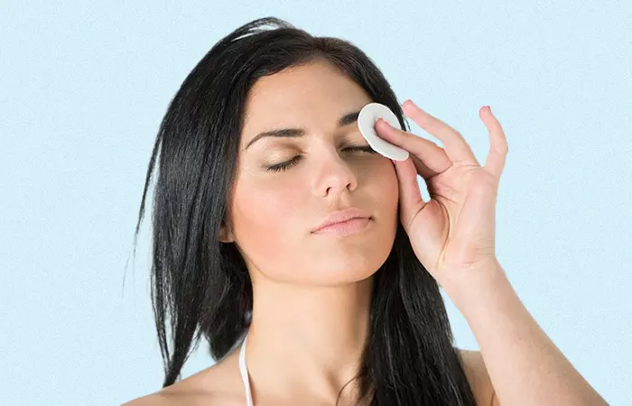 Woman wiping her eyebrows using a clean, sterile cotton pad