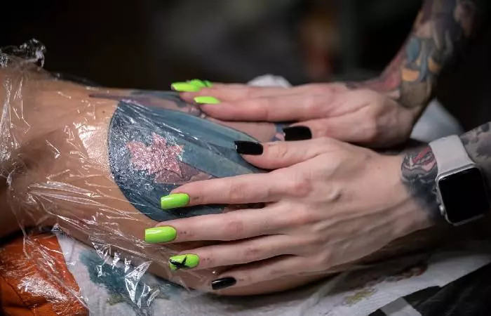 Wrapping a fresh tattoo on the arm