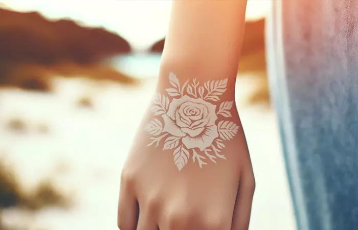 White ink rose tattoo on light skin 