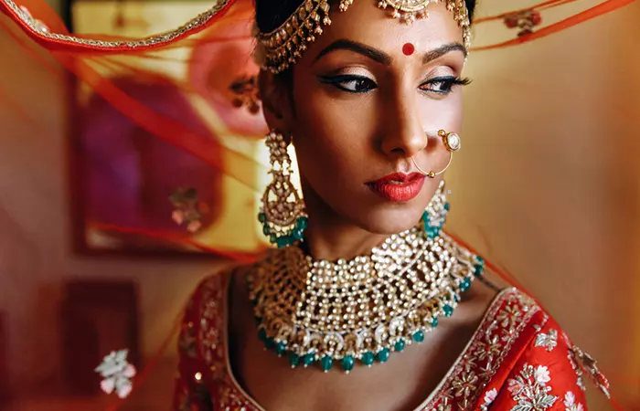 A beautiful Hindu bride wearing a nose ring and earrings