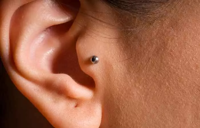 A close up of a  tragus piercing