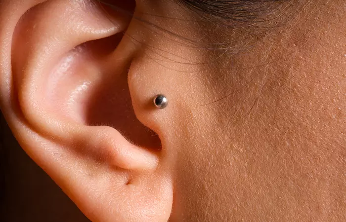 A close up of a tragus piercing