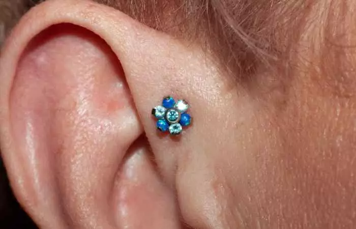 A floral stud on a forward helix piercing