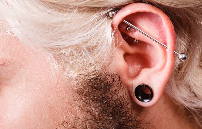 A man sports a rook piercing