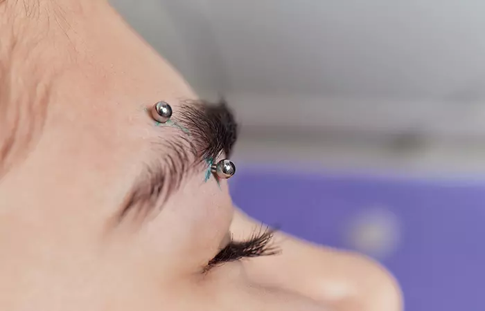 A straight barbell eyebrow piercing