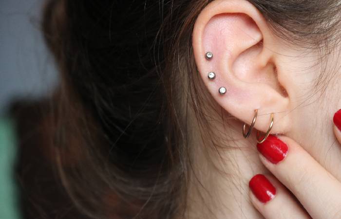 A woman sports a high-lobe piercing