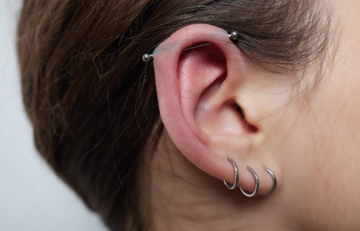 A woman sports an industrial piercing