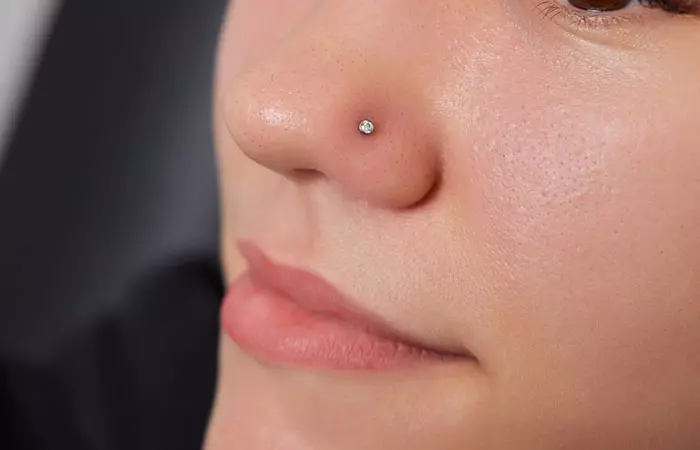 A woman wearing a stud in her nose piercing