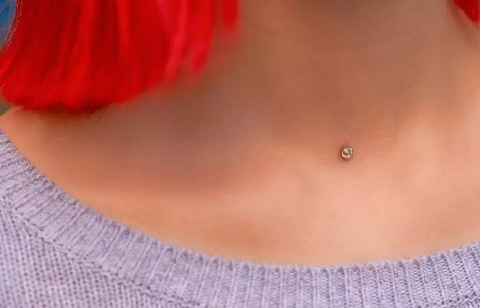 A woman with a dermal piercing