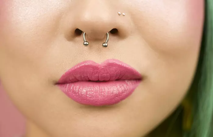 A woman with a double nose piercing and a septum piercing