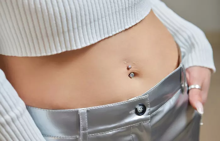 A woman with a healed navel piercing