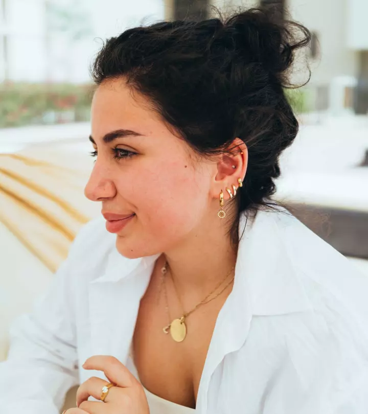 A woman with ear multiple piercings