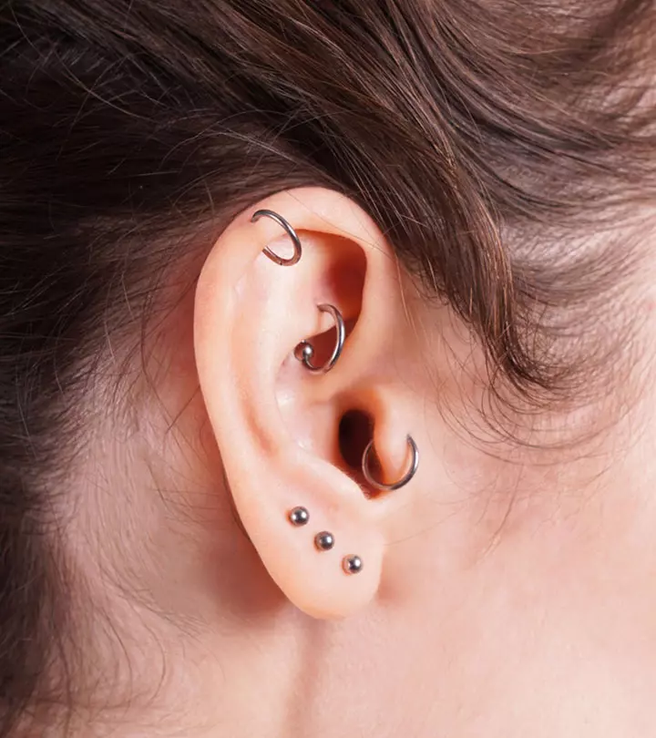 A woman with lobe and cartilage piercings