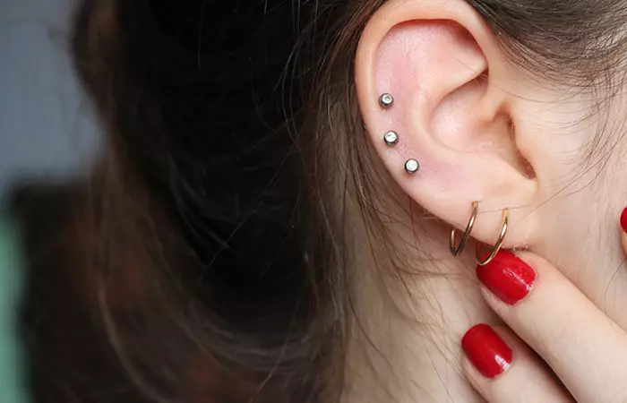 A woman with lobe and helix piercings