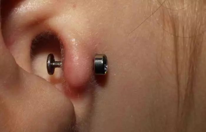 An extreme closeup of a tragus piercing