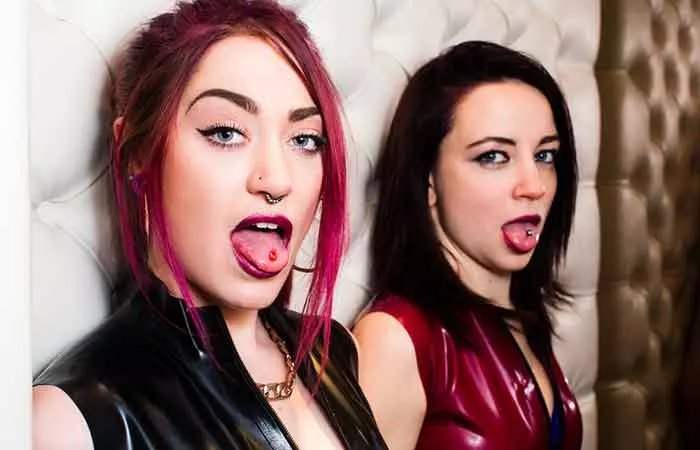 Two friends flaunt their tongue piercing