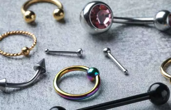 Close-up of various kinds of piercing jewelry on a table