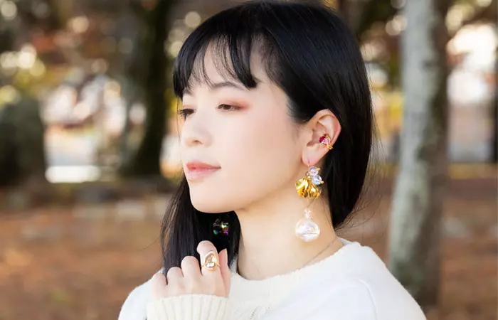 A woman wearing conch ear cuffs