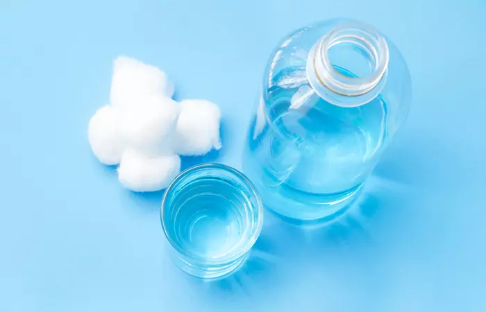Cotton balls and saline solution for cleaning the infected piercing