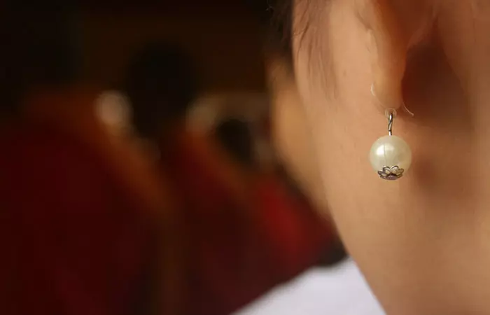 A woman with dangle earrings