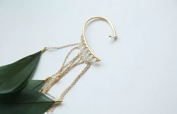 Ear cuffs with a chain resting on a table