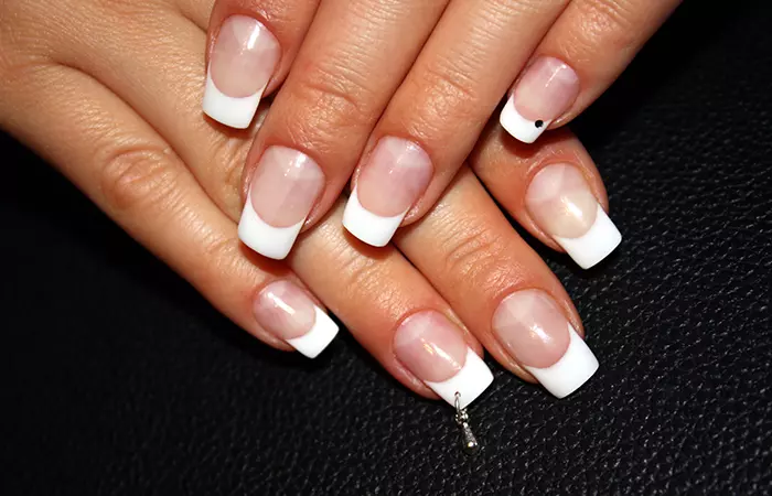 French manicure with nail piercings