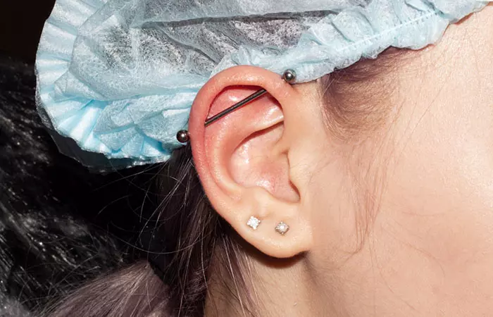 A woman with a horizontal industrial piercing