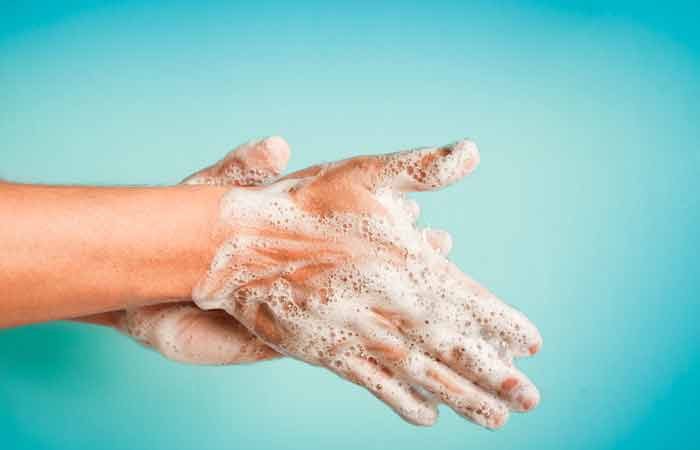 A woman washing her hands before touching her piercing