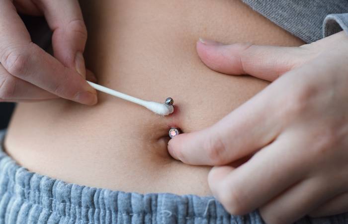 How to care for infected belly button on sale piercing