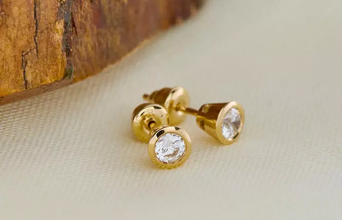 A set of gold earrings to be used in curated ear piercings