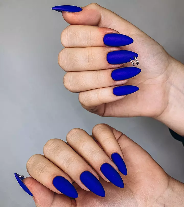 Nails piercings on a blue manicure