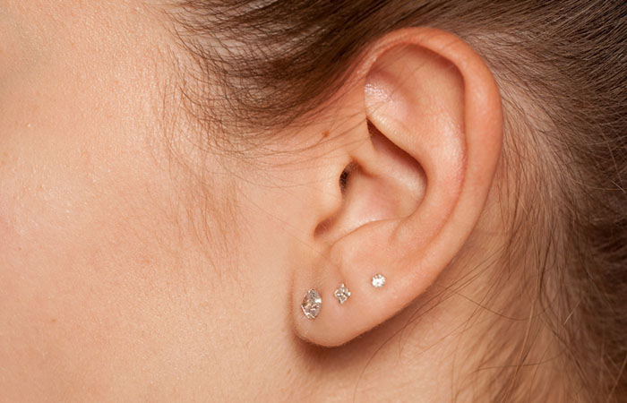 A woman with triple lobe piercings