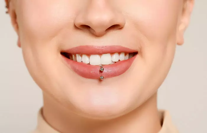 Woman smiling with a lip piercing