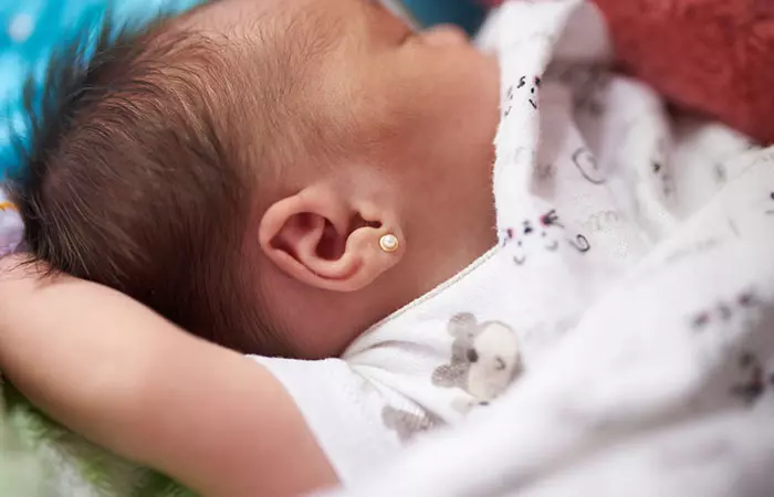 A baby with an ear piercing