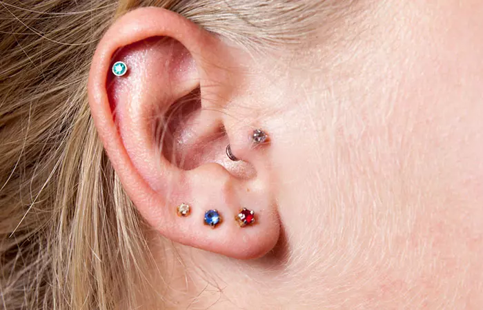 A woman flaunts her curated ear piercings