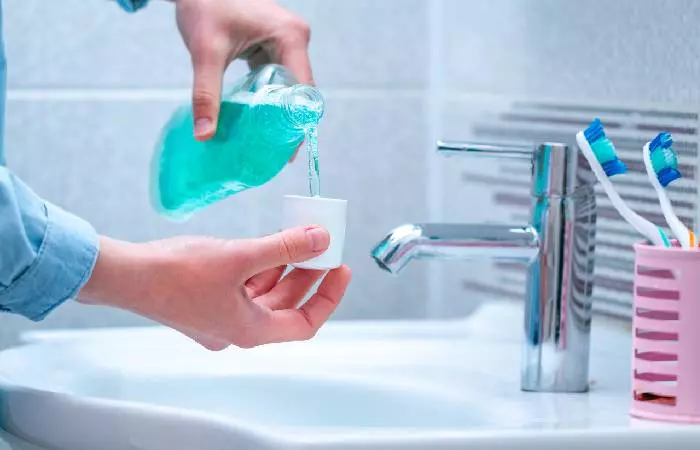 Woman using an antibacterial mouthwash