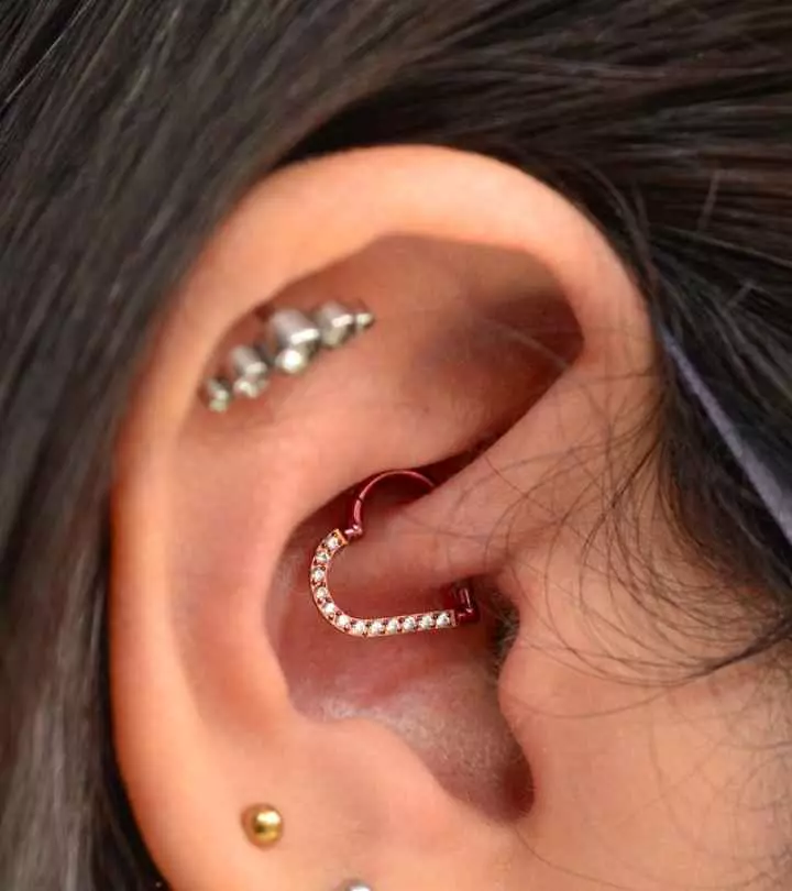 Woman wearing heart-shaped jewelry on her daith piercing