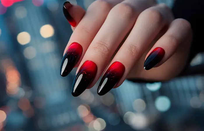 Black and red nail design with an ombre effect