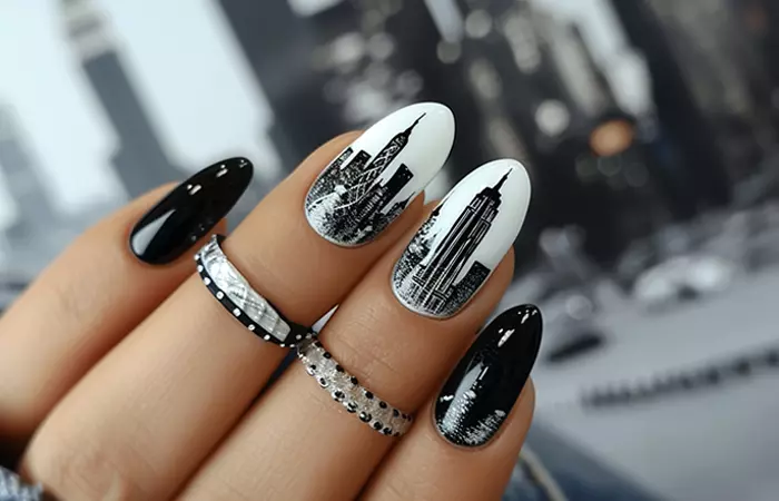 Black and white nail design featuring a city skyline