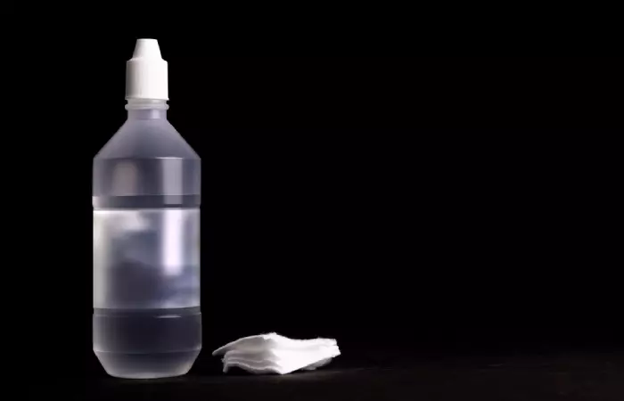 A bottle of saline solution and cotton