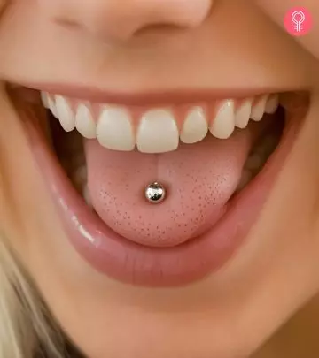 A happy woman with a tongue piercing