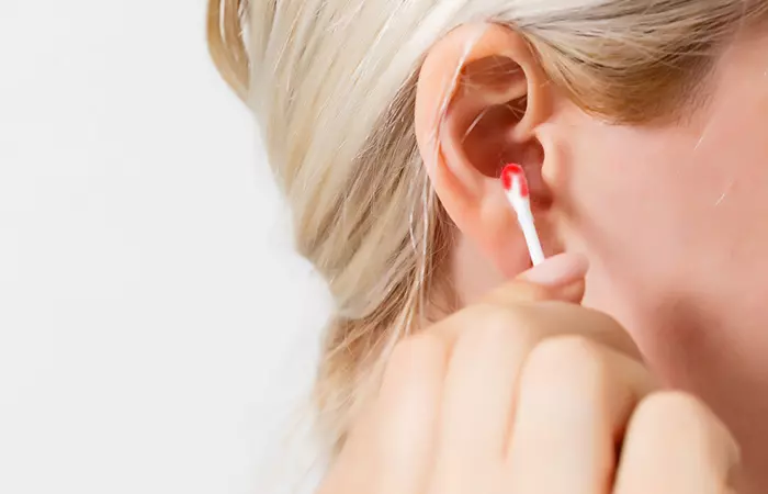 A woman bleeding from her ear 