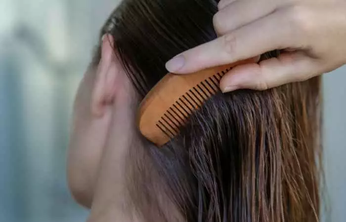 A woman combing damp hair